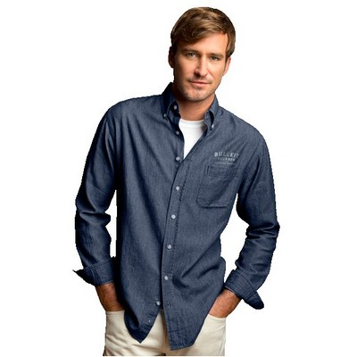 man wearing blue denim (chambray) button-down shirt with left chest logo