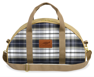 half-moon duffel bag in navy blue and white plaid with tan canvas handles and strap