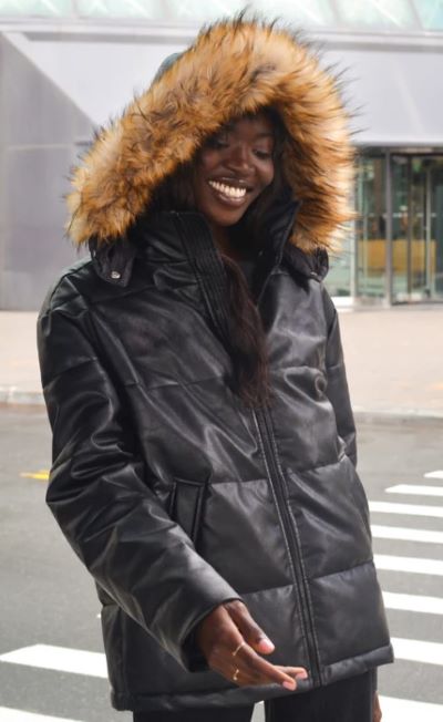 woman wearing black vegan leather puffer coat with hood with brown faux-fur trim