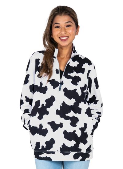 woman wearinf black and white cow print quarter zip sweatshirt