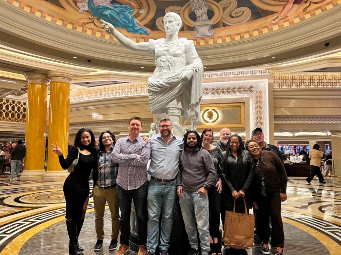 The PPAI Media and Membership Team smile in front of a statue in Caesar's Palace in Vegas during The PPAI Expo 2023.