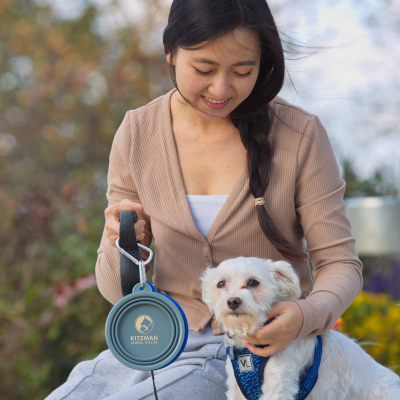 woman with dog and holding collapsible flat water bowl