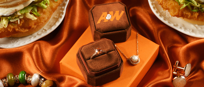 A&W Restaurants "The Cod Collection" jewelry on orange background