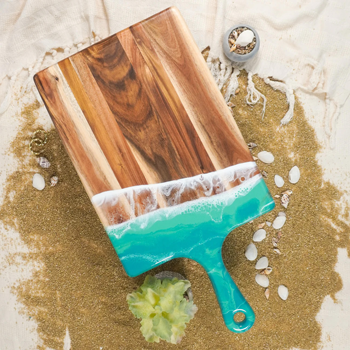 acacia cheese board with Caribbean Blue surf decorated resin handle
